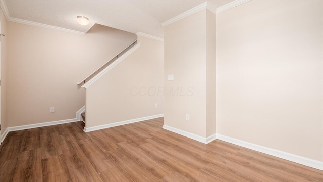 776 Brevard Cir, Pickerington, OH 43147 - basement featuring light wood-style flooring, stairs, ornamental molding, baseboards, and a textured ceiling