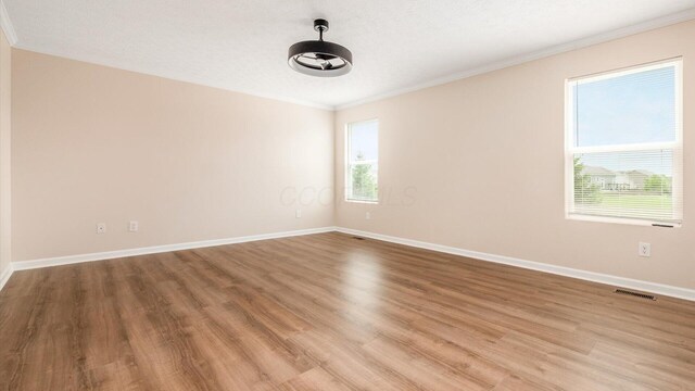 776 Brevard Cir, Pickerington, OH 43147 - unfurnished room with crown molding, wood finished floors, and baseboards