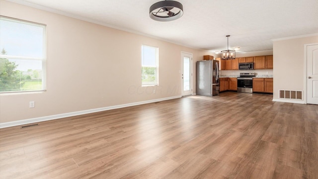 776 Brevard Cir, Pickerington, OH 43147 - unfurnished living room featuring ornamental molding, healthy amount of natural light, wood finished floors, and baseboards