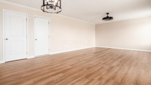 776 Brevard Cir, Pickerington, OH 43147 - unfurnished room featuring ornamental molding, light wood-style flooring, baseboards, and a chandelier