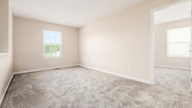 776 Brevard Cir, Pickerington, OH 43147 - unfurnished room with carpet, baseboards, and a textured ceiling