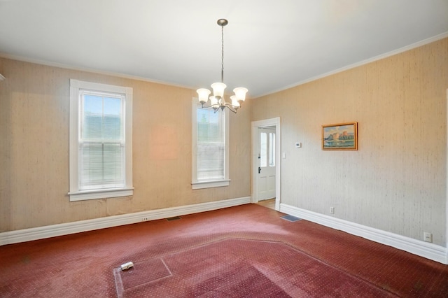 699 S Front St, Columbus, OH 43206 - spare room featuring crown molding, a chandelier, carpet, and baseboards
