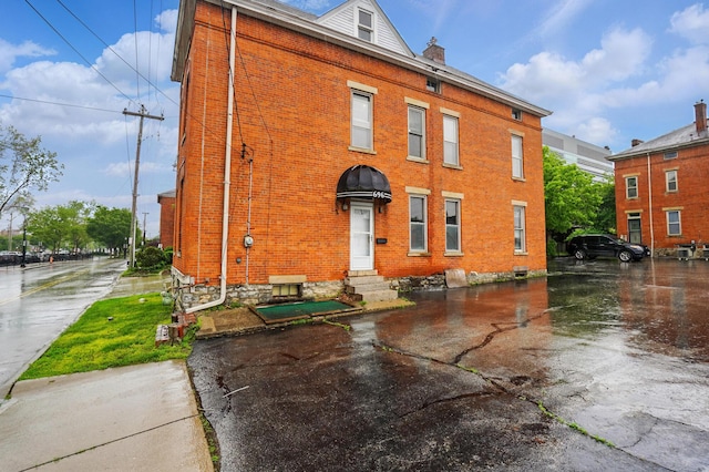 696 Bank St, Columbus, OH 43206 - rear view of property featuring brick siding, entry steps, and a chimney