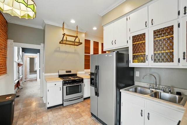 696 Bank St, Columbus, OH 43206 - kitchen featuring stainless steel gas range, fridge with ice dispenser, a sink, ornamental molding, and white cabinets