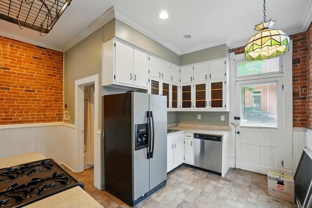 696 Bank St, Columbus, OH 43206 - kitchen with appliances with stainless steel finishes, brick wall, ornamental molding, light countertops, and wainscoting