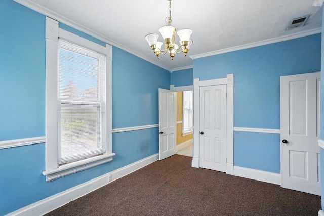 696 Bank St, Columbus, OH 43206 - unfurnished bedroom featuring a chandelier, dark carpet, ornamental molding, and baseboards