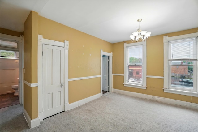 696 Bank St, Columbus, OH 43206 - carpeted empty room featuring a chandelier and baseboards