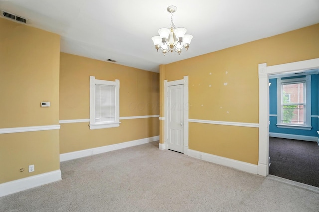 696 Bank St, Columbus, OH 43206 - carpeted empty room featuring a chandelier and baseboards