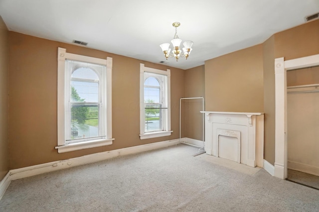 696 Bank St, Columbus, OH 43206 - unfurnished living room featuring a chandelier, carpet floors, and baseboards