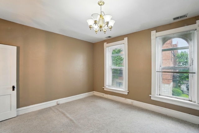 696 Bank St, Columbus, OH 43206 - unfurnished room featuring a chandelier, healthy amount of natural light, carpet floors, and baseboards