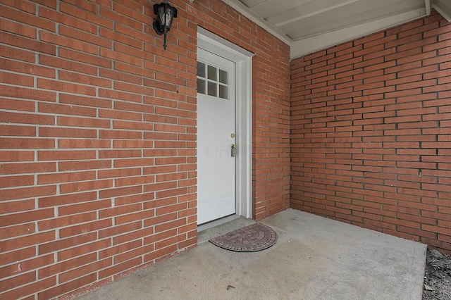 doorway to property with brick siding