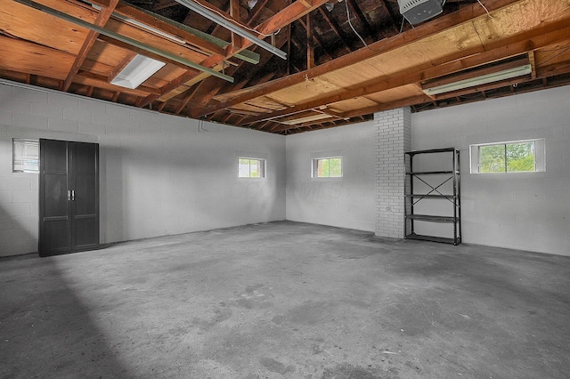 garage with concrete block wall and a garage door opener