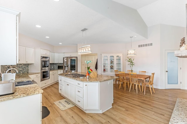 1885 Greenbriar Way, Nashport, OH 43830 - kitchen with stainless steel appliances, decorative backsplash, white cabinets, light wood-style flooring, and lofted ceiling