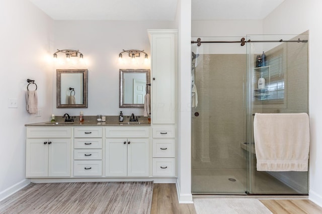 1885 Greenbriar Way, Nashport, OH 43830 - full bath featuring wood finished floors, a stall shower, double vanity, and baseboards