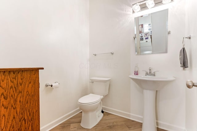 1885 Greenbriar Way, Nashport, OH 43830 - bathroom featuring wood finished floors, toilet, and baseboards