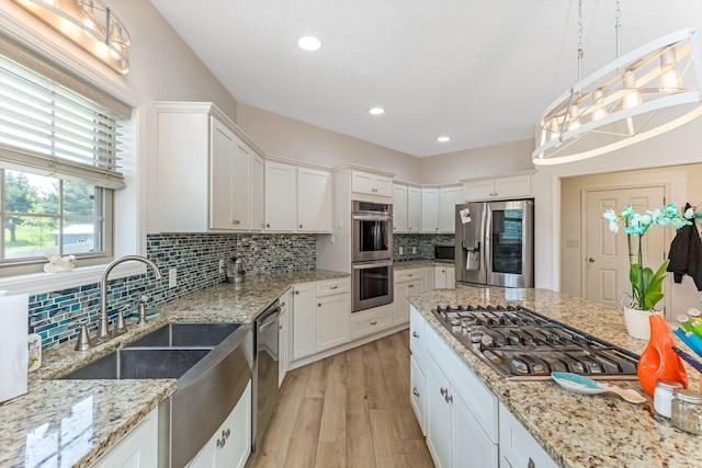 1885 Greenbriar Way, Nashport, OH 43830 - kitchen with stainless steel appliances, white cabinets, decorative backsplash, a sink, and recessed lighting