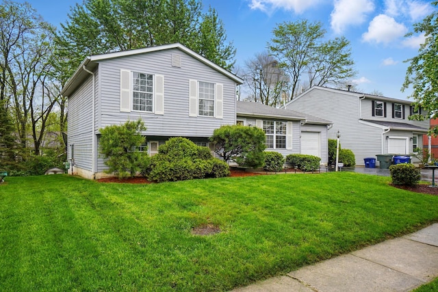 split level home with a garage and a front yard