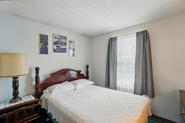 bedroom featuring a textured ceiling