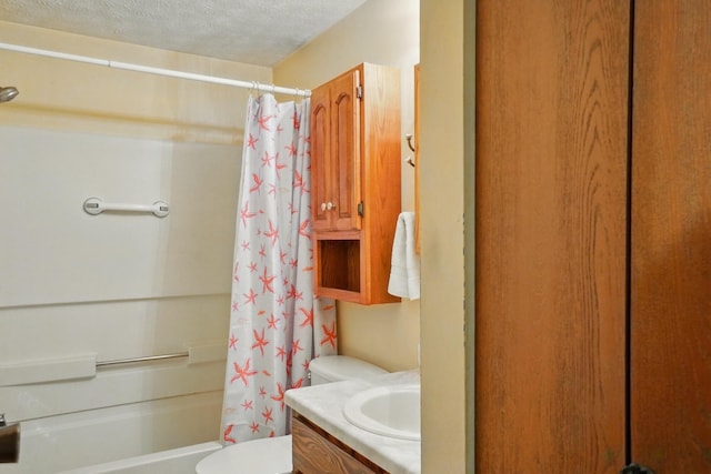 bathroom featuring vanity, toilet, shower / bath combo with shower curtain, and a textured ceiling