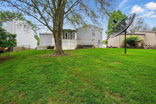 view of grassy yard featuring a wooden deck