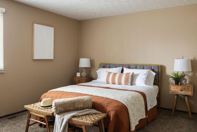 carpeted bedroom featuring baseboards and a textured ceiling