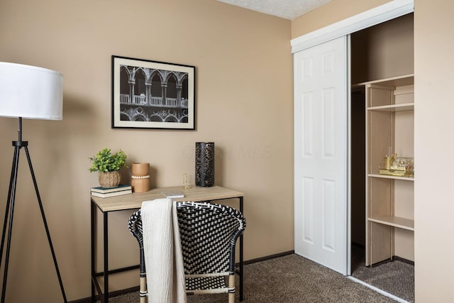 interior space featuring dark colored carpet and baseboards