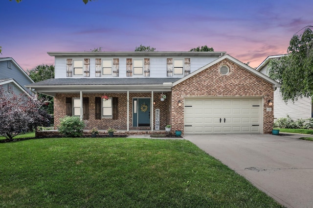 113 Bridgeport Way, Delaware, OH 43015 - view of front of property with a garage, brick siding, driveway, a front yard, and a porch
