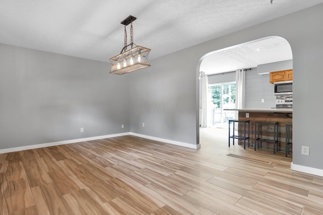 113 Bridgeport Way, Delaware, OH 43015 - unfurnished room with arched walkways and light wood-style floors