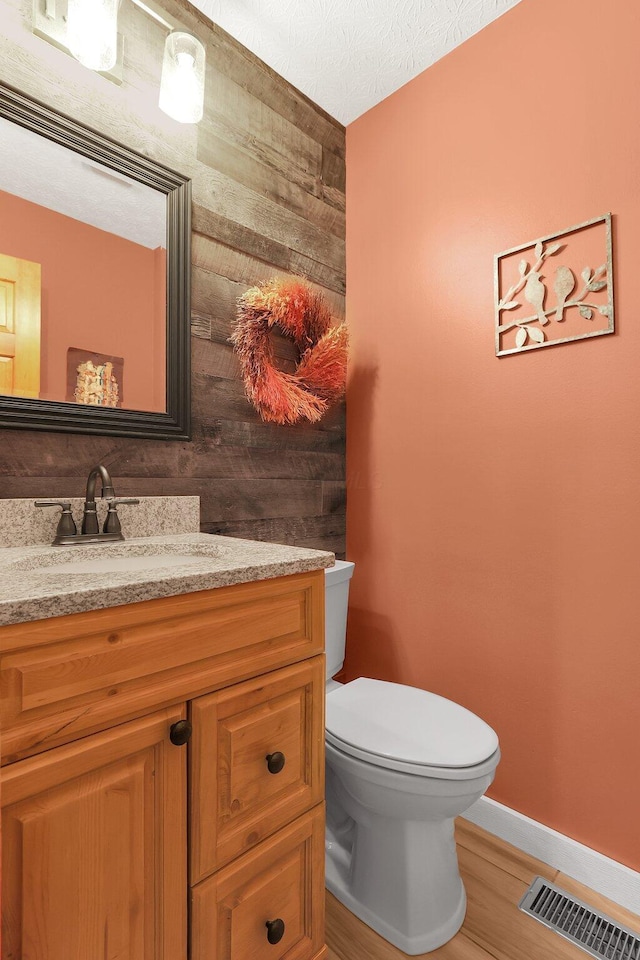 113 Bridgeport Way, Delaware, OH 43015 - bathroom featuring vanity, wooden walls, and wood finished floors