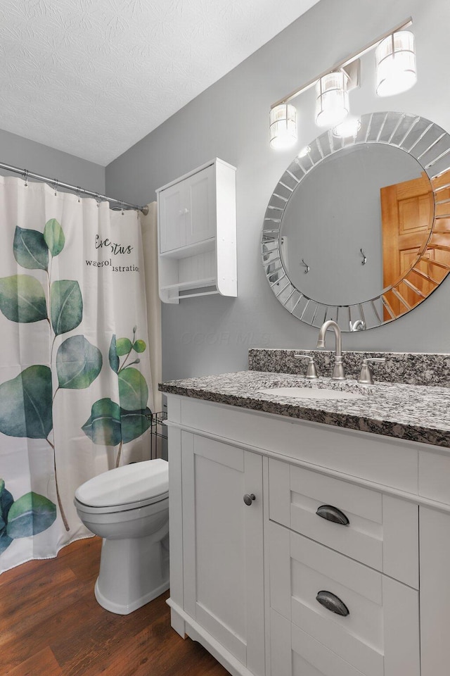 113 Bridgeport Way, Delaware, OH 43015 - full bath with wood finished floors, vanity, a textured ceiling, and a shower with shower curtain