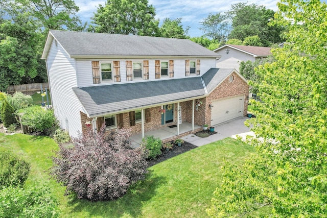 113 Bridgeport Way, Delaware, OH 43015 - view of front of home featuring covered porch, an attached garage, a front yard, and brick siding