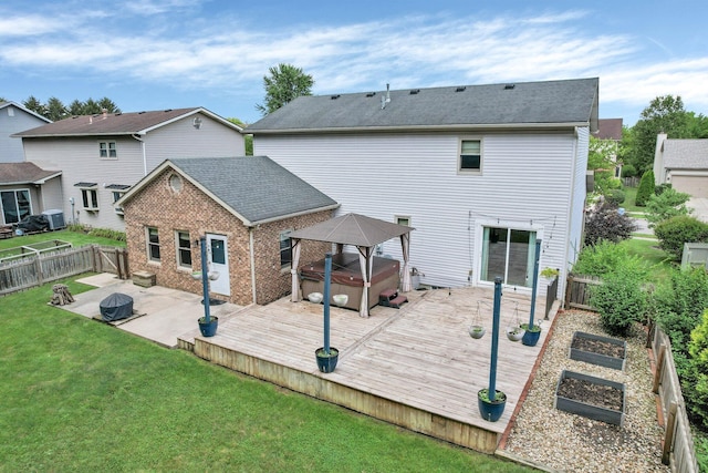 113 Bridgeport Way, Delaware, OH 43015 - rear view of house featuring a gazebo, a hot tub, a fenced backyard, a garden, and a wooden deck