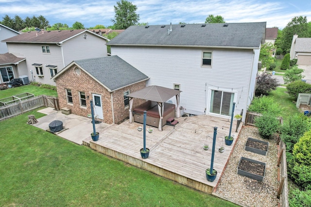113 Bridgeport Way, Delaware, OH 43015 - rear view of house with a hot tub, a garden, a fenced backyard, a patio area, and a wooden deck