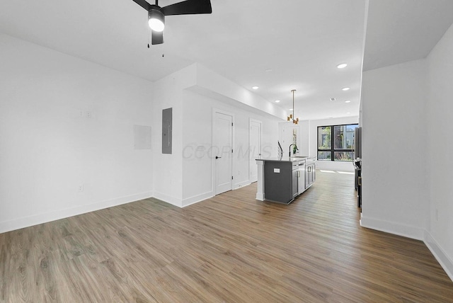 1106 Oak St Unit 12, Columbus, OH 43205 - kitchen with a center island with sink, wood finished floors, recessed lighting, baseboards, and ceiling fan