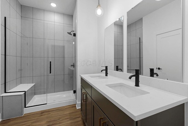 1106 Oak St Unit 12, Columbus, OH 43205 - bathroom featuring a stall shower, wood finished floors, double vanity, and recessed lighting