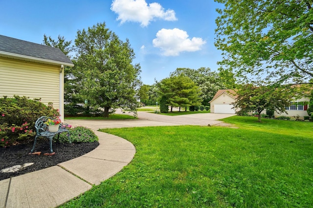 415 Yencer St, Baltimore, OH 43105 - view of grassy yard featuring driveway and a garage