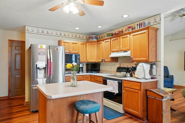 415 Yencer St, Baltimore, OH 43105 - kitchen with under cabinet range hood, a ceiling fan, range with electric stovetop, stainless steel refrigerator with ice dispenser, and light wood-type flooring