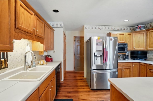 415 Yencer St, Baltimore, OH 43105 - kitchen with black appliances, a sink, wood finished floors, light countertops, and tasteful backsplash