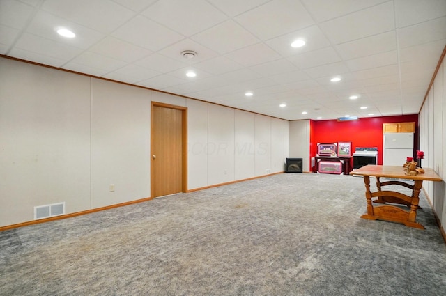 415 Yencer St, Baltimore, OH 43105 - living area featuring carpet flooring, baseboards, recessed lighting, a drop ceiling, and a wood stove