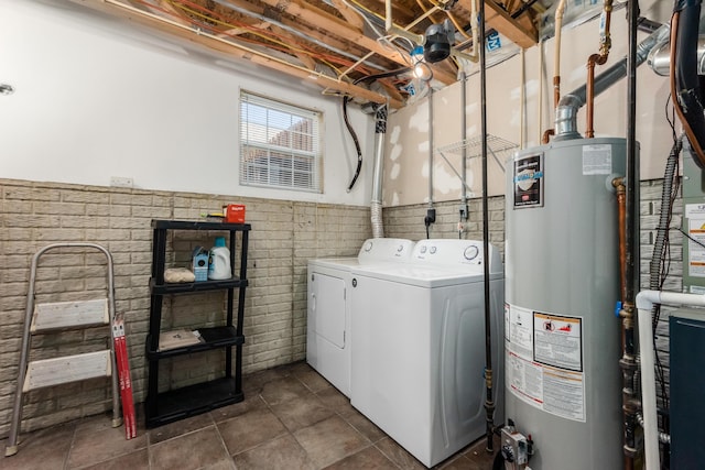 5958 Central College Rd, New Albany, OH 43054 - clothes washing area with washing machine and clothes dryer, gas water heater, and wainscoting