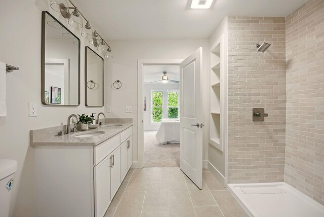 436 W 2nd Ave, Columbus, OH 43201 - ensuite bathroom featuring a ceiling fan, tile patterned flooring, tiled shower, built in features, and double vanity