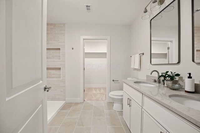 436 W 2nd Ave, Columbus, OH 43201 - bathroom with a shower stall, toilet, double vanity, tile patterned flooring, and baseboards