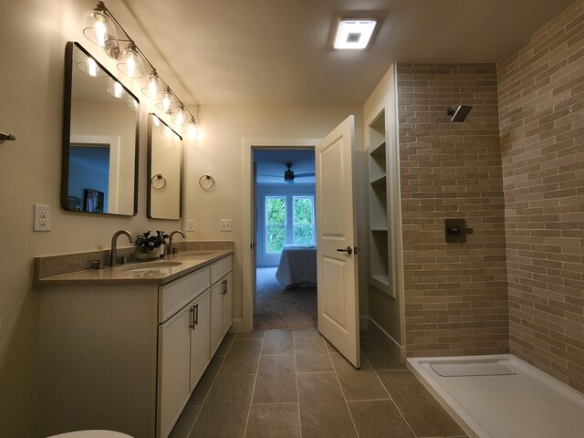 436 W 2nd Ave, Columbus, OH 43201 - bathroom with tile patterned flooring, a tile shower, brick wall, double vanity, and built in shelves