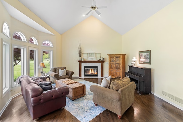 5098 Cascade Dr, Powell, OH 43065 - living room with high vaulted ceiling, ceiling fan, a fireplace with flush hearth, dark wood-style flooring, and baseboards