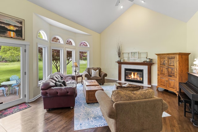 5098 Cascade Dr, Powell, OH 43065 - living area with high vaulted ceiling, a high end fireplace, dark wood-style floors, ceiling fan, and baseboards