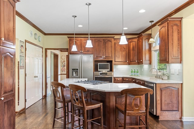 5098 Cascade Dr, Powell, OH 43065 - kitchen with stainless steel appliances, a sink, ornamental molding, decorative backsplash, and light countertops