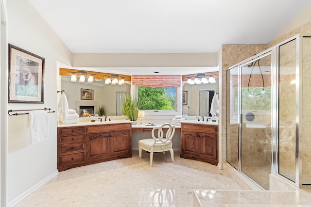 5098 Cascade Dr, Powell, OH 43065 - bathroom with a stall shower, vanity, a glass covered fireplace, and baseboards