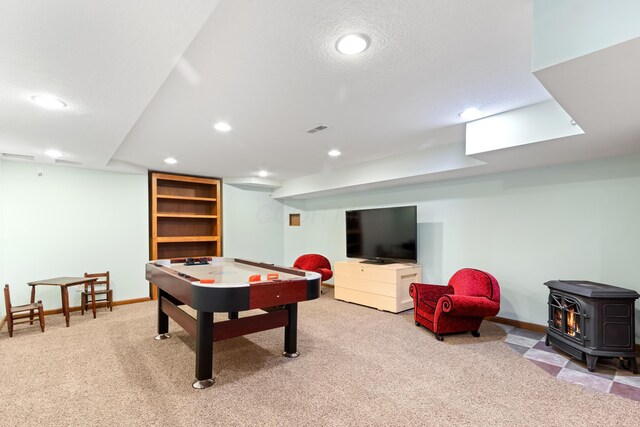 5098 Cascade Dr, Powell, OH 43065 - recreation room with carpet, recessed lighting, a wood stove, baseboards, and a textured ceiling