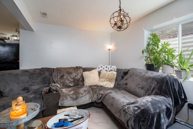 447 Wingate Pl, Mount Sterling, OH 43143 - living area featuring light marble finish flooring and a chandelier