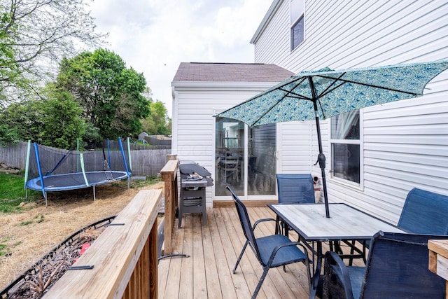 447 Wingate Pl, Mount Sterling, OH 43143 - deck with a trampoline, outdoor dining area, fence, and area for grilling